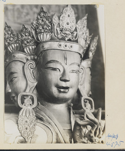 Detail showing heads of a multi-headed Lamaist deity with six arms at Yong he gong