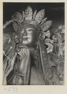 Detail of crowned Lamaist deity at Yong he gong showing head and hand