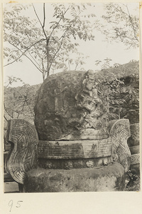 Detail of carved stone ding with relief figures at Gang Tie miao
