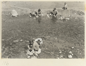 Women washing clothes in the river near Hei long tan