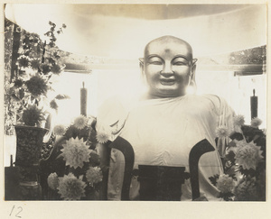 Temple interior at Xi yu si showing a detail of a draped Buddha statue