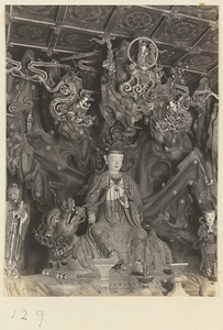 Temple interior at Bi yun si showing an altar with a statue of a Bodhisattva seated on a lion
