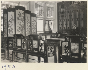 Temple building interior at Kai yuan Temple Pagoda showing painted screen, clock, wooden furniture, lanterns, and latticework partitions and windows