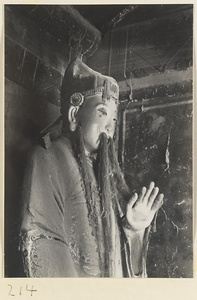 Bearded shrine figure with raised hand at the Old Wu Garden