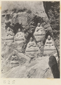 Buddha reliefs cut into the hillside at Yuquan Hill