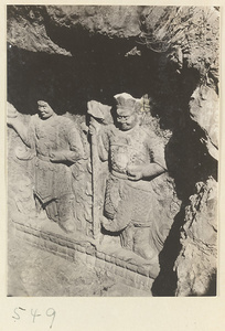 Two Buddhist relief figures carved into the hillside at Yuquan Hill