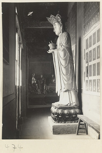 Temple interior showing a statue of a Bodhisattva holding a vessel