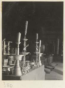 Interior of temple building showing altar with ritual objects at Da jue si