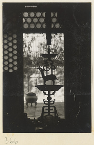Candlestick silhouetted in a window at Da jue si