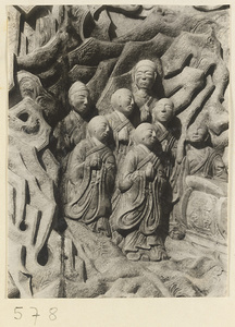 Detail of a pagoda showing a relief carving with Buddhist figures at Huang si