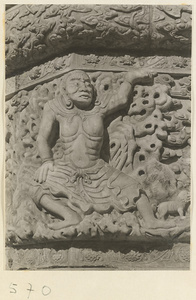 Detail of a pagoda showing a relief carving with a Buddhist figure at Huang si