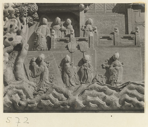 Detail of a pagoda showing a relief carving with a Buddhist scene at Huang si