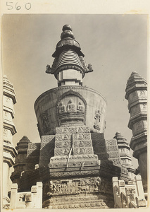 Detail of stupa-style pagoda at Huang si showing carved relief work with Buddhist figures and scenes