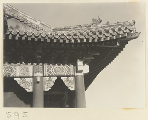 Exterior detail of temple roof showing ornaments and painted beams at Huang si