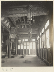 Temple interior showing inscriptions, lanterns, and benches at Fa yuan si