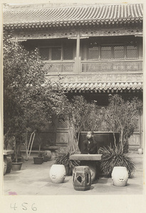 Boy in courtyard in front of the Scripture Library at Fa yuan si