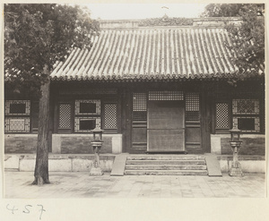 Facade detail of a temple building showing entrance and a pair of lanterns at Fa yuan si