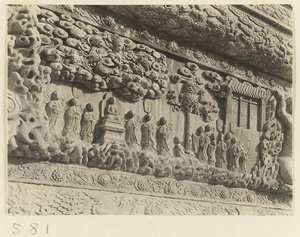 Detail of a pagoda showing a relief carving with a Buddhist scene at Huang si