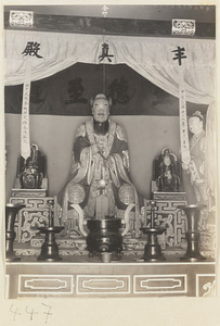 Temple interior showing altar with Daoist statues, inscriptions, and ritual objects at Bai yun guan