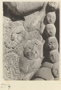 Detail of relief at Yuquan Hill showing hand, head, and necklace of skulls