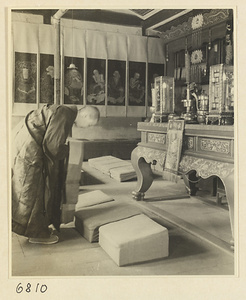 Buddhist nun bowing at altar