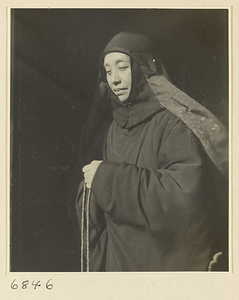 Buddhist nun holding a string of rosary beads