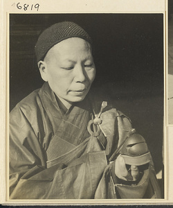 Buddhist nun striking a mu yu