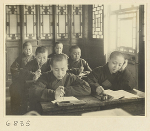 Buddhist nuns writing at desks