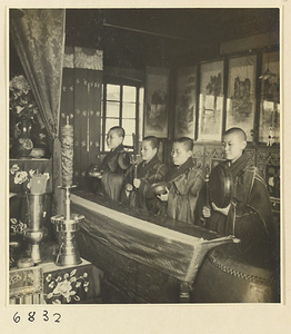 Buddhist nuns playing musical instruments during service