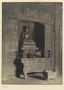 Interior of Wan shan dian showing altar and niche with statue of Buddha
