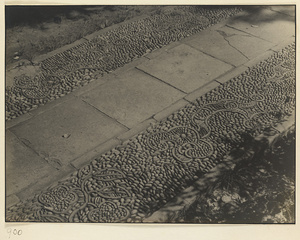 Walkway with decorative paving of pebbles and tile shards arranged in the shape of a ru yi sceptre