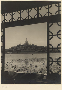 View over Beihai Lake towards Qiong Island showing Bai ta at summit and Yu lang along the north shore