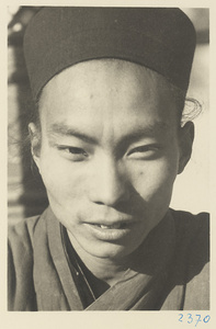 Daoist priest wearing a hat at Bai yun guan