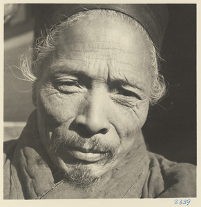 Daoist priest wearing a hat at Bai yun guan