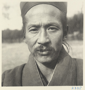 Daoist priest wearing a hat at Bai yun guan