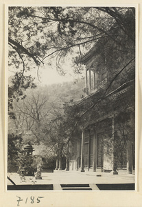 Facade detail of a two-story temple building at Jie tai si showing terrace with incense burner