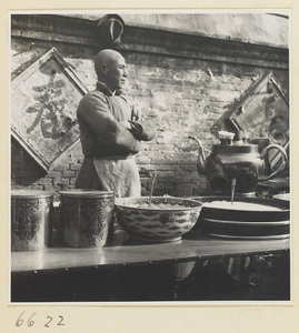 Food stand showing vendor, inscribed metal containers, ceramic serving bowl, food, and teapot