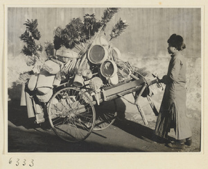 Household goods vendor pushing his cart