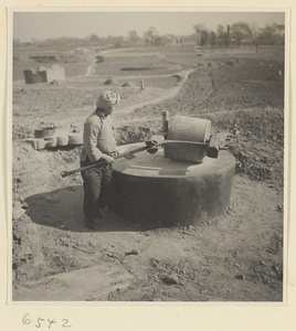 Man turning a grindstone