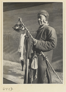 Hawker selling fur ear muffs