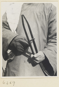 Street barber playing an iron huang or suo zi to attract customers