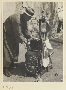 Street barber with his equipment