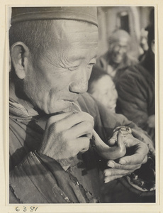 Candy vendor blowing candy into the form of a bird