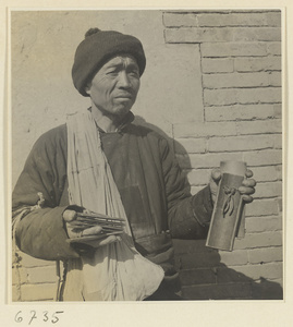 Itinerant story teller holding wooden castanets