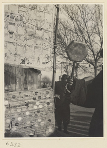 Tracery candy vendor holding a drum called a da tao