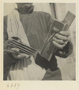 Itinerant story teller holding wooden castanets