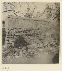 Woman splitting reeds at a mat-making shop