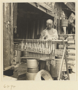 Man weaving a door curtain