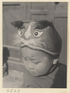 Child wearing a hat with animal-face motif