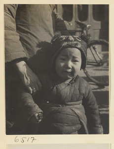 Child wearing a hat with animal-face motif